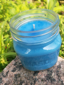 Blue Soy candle without a lid in an 8 oz Mason jar.