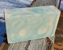 Blue and white soap, sitting on a railing.  The bar is a minimum of 3.8 oz.
