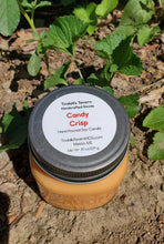 Candy Crisp Soy candle that is orange in color in an 8 oz Mason jar with a pewter lid.