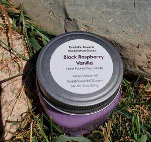 Black Raspberry Vanilla Soy candle that is purple in color in an 8 oz Mason jar with a pewter lid.