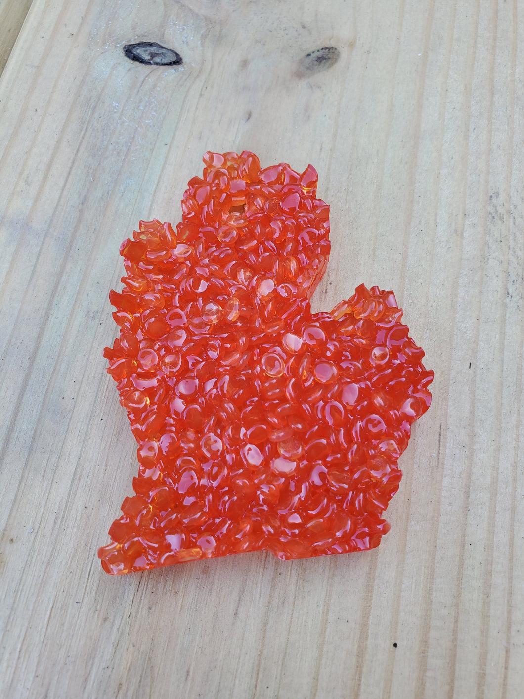 Orange hanging mitten air freshener.