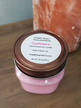 Cashmere Soy candle that is light pink in color in an 8 oz Mason jar with a pewter lid.