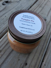 Pumpkin Pie Soy candle that is orangish-brown in color in an 8 oz Mason jar with a copper lid.