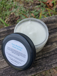 Jar of Cool Menthol Foot Scrub with the cap off to show it's contents, which is whitish in color in a 4 oz plastic jar.