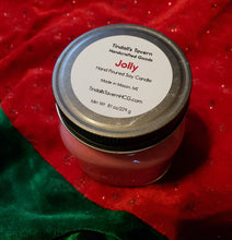 Jolly Soy candle that is red in color in an 8 oz Mason jar with a pewter lid.