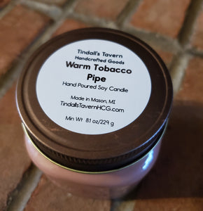 Warm Tobacco Pipe Soy candle that is dark tan in color in an 8 oz Mason jar with a copper lid.