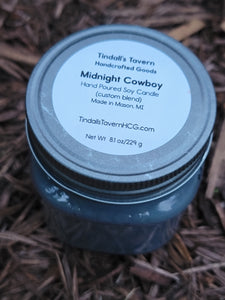 Midnight Cowboy Soy candle that is dark gray in color in an 8 oz Mason jar with a pewter lid.