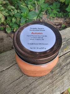 Autumn Soy candle that is orangeish in color in an 8 oz Mason jar with a copper lid.
