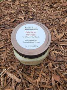 Palo Santo Patchouli Soy candle that is white in color in an 8 oz Mason jar with a pewter lid.